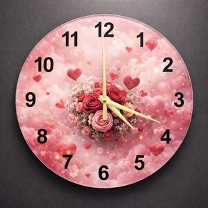 May include: Circular wall clock with a pink design of hearts and clouds. The clock face has black numerals and gold hands. A floral arrangement of red and pink roses is in the centre.