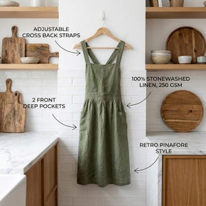 May include: Olive green linen apron with adjustable cross-back straps, two front deep pockets, and a retro pinafore style. The apron is made of 100% stonewashed linen, 250 GSM.