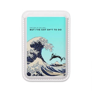 May include: A white phone case featuring a stylized wave design with a whale leaping from the crest. The background is a light blue with the text "THE SEA IS CALLING... BUT I'VE GOT SH*T TO DO".