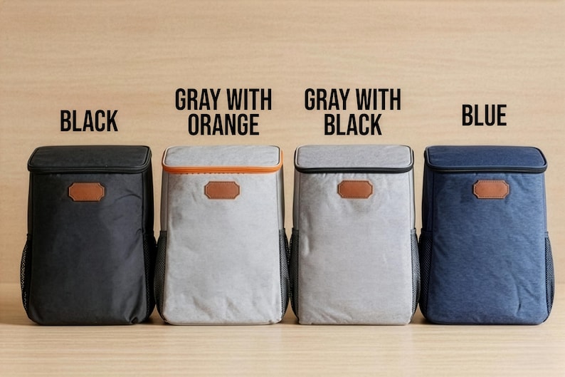May include: Four cooler backpacks in black, grey with orange trim, grey with black trim, and blue. Each has a brown leatherette patch and a mesh side pocket. Text above each bag indicates the colour.