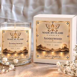May include: A clear glass candle jar and a white cardboard box, both featuring a label with a gold butterfly, mountain landscape, and the text Made By Flame Candles Sandlewood Soy Coconut Wax Candle 10 oz 283 g Light up a Brighter You.