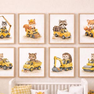 May include: A collection of eight framed watercolour prints. Each print depicts a different animal, such as a fox or raccoon, operating a yellow construction vehicle. The prints are suitable for a nursery or children's room. The frames are a light brown colour.