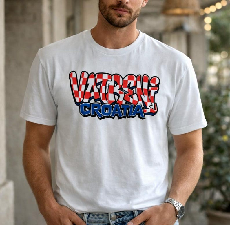 May include: White t-shirt featuring the text "VATRENI CROATIA" in a red and white checkered design with a blue outline. The shirt is short-sleeved and made of a soft material.