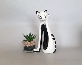 Tall lean black and white pottery cat