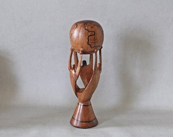 World Unity carved sculpture. Hand  carved wood globe supported by figures