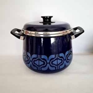 May include: A navy blue enamel pot with a lid and two handles. The pot has a silver rim and a light blue geometric pattern around the base. The lid has a black handle.