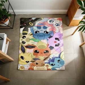 May include: A rectangular area rug featuring a colorful, detailed illustration of various Eevee evolution characters including Umbreon, Sylveon, Flareon, Jolteon, Vaporeon, and others, arranged in a dense, overlapping pattern with soft pastel tones.