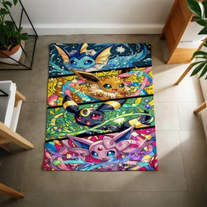 May include: A rectangular throw blanket featuring a vibrant, multi-paneled graphic print of four distinct fictional creatures. The top panel shows a blue water-type creature, followed by a brown creature, a black and yellow creature, and a pink creature.
