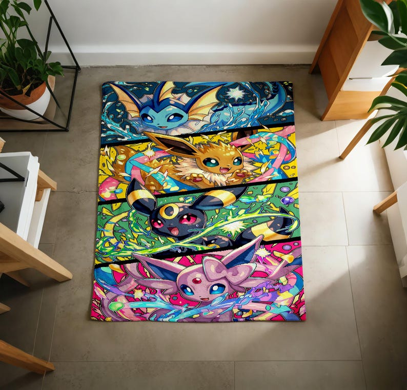 May include: A rectangular throw blanket featuring a vibrant, multi-paneled graphic print of four distinct fictional creatures. The top panel shows a blue water-type creature, followed by a brown creature, a black and yellow creature, and a pink creature.