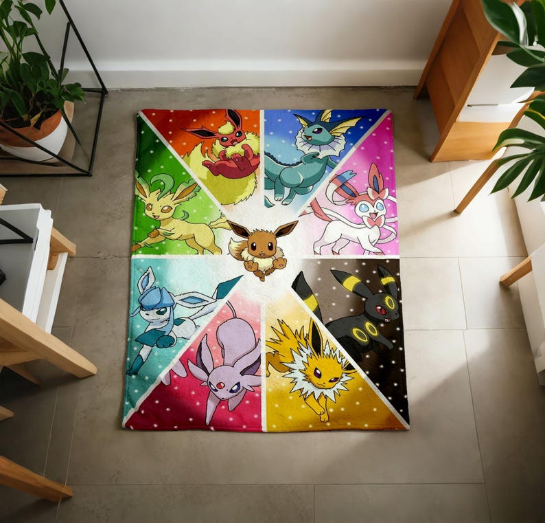 May include: A rectangular blanket featuring a central brown Eevee surrounded by eight colorful triangular segments, each displaying a different Eevee evolution character including Flareon, Vaporeon, Sylveon, Umbreon, Jolteon, Espeon, Glaceon, and Leafeon.
