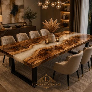 May include: A large, rectangular dining table with a brown and white epoxy resin design. The table is supported by a black metal frame and surrounded by beige upholstered chairs. The logo "LUXURYSTONEMADE" is visible.