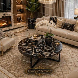 May include: A circular coffee table featuring a black and white agate stone surface. The table is supported by a black metal frame and is set on a beige rug. The table's diameter is approximately 122 cm.