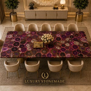 May include: A large, rectangular dining table with a vibrant, patterned surface in shades of purple, brown, and white. The table is surrounded by ten beige chairs. The image is taken from an elevated angle, showcasing the luxurious design. The table is part of the Luxury Stonemade collection.