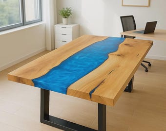 May include: A rectangular wooden table with a vibrant blue epoxy river running through the center. The table has a natural wood grain finish and is supported by black metal legs. The table measures approximately 72 inches long.