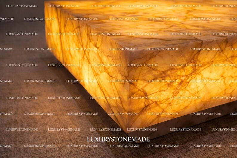 Luxury white onyx coffee table with integrated LED backlighting crafted from natural gemstone slab featuring polished crystal surface and vibrant translucent mineral layers designed for designer living rooms and modern penthouse interiors across the United States. Illuminated stone creates dramatic centerpiece furniture.