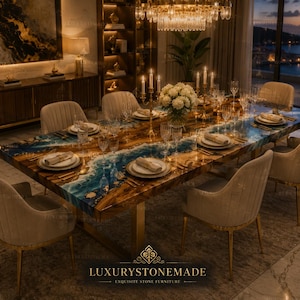 May include: A large, rectangular dining table with a unique epoxy resin design, featuring a blend of blue, brown, and gold tones, set for a formal dinner. The table is surrounded by upholstered chairs and elegant place settings. The table is approximately 100 inches long.