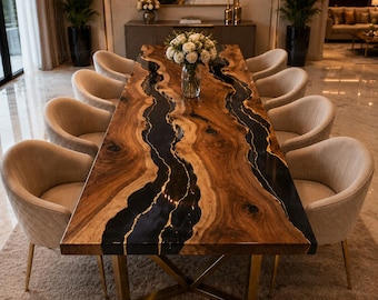 May include: A large, rectangular dining table with a distinctive wood grain and black resin detailing. Ten beige upholstered chairs with gold legs surround the table. The table is supported by a gold metal base. The text "LUXURYSTONEMADE" is at the bottom.