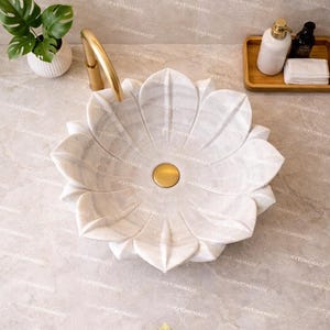 Premium white marble floral sink handcrafted with lotus design showcasing detailed carving smooth finish and natural veining ideal for luxury bathroom interiors contemporary spaces and designer decor enhancing aesthetic appeal