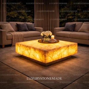 Exotic white onyx illuminated coffee table made from natural gemstone slab with polished translucent surface and integrated LED lighting designed for luxury contemporary interiors and upscale residential homes throughout the USA. Natural mineral layers glow through the stone creating a dramatic luminous coffee table centerpiece.