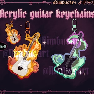 May include: Two acrylic guitar keychains with metal clasps. One features a white electric guitar surrounded by orange and yellow flames. The other shows a black electric guitar with green and purple smoke. Text reads Acrylic guitar keychains.