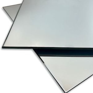 May include: A set of three ceramic mugs with a speckled, matte finish. The mugs are in shades of cream, light gray, and dark gray. Each mug has a simple, minimalist design and a rounded handle. The mugs are likely for coffee or tea.