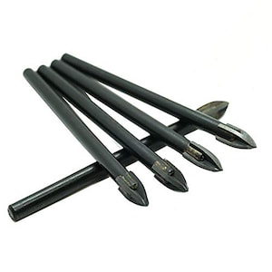 May include: A collection of five black glass drill bits with pointed tips. The drill bits are arranged at an angle against a white background. The tips are a silver color.
