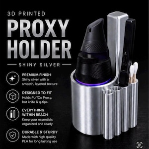 May include: 3D printed shiny silver Proxy Holder. The holder is designed to fit a PuffCo Proxy, hot knife, and q-tips. The holder is made with high-quality PLA for long-lasting use. The text on the holder says "Premium Finish" and "Everything Within Reach."