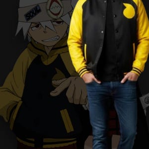 May include: Black and yellow varsity jacket with a circular yellow patch on the chest. The jacket has yellow sleeves and black body. The image also features a cartoon character in the background.