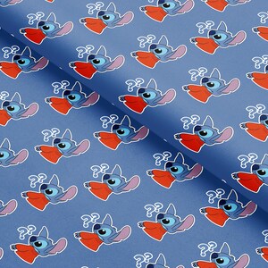 May include: Blue fabric with a repeating pattern of a cartoon character with blue fur, large ears, and a red mouth. The character has a question mark above its head. The background is a solid blue color.