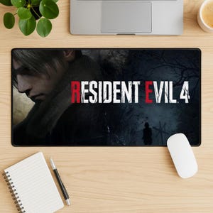 May include: Black rectangular mousepad featuring the text "RESIDENT EVIL 4" in white and red. The mousepad has a dark, detailed graphic of a character and a forest scene. A white mouse is on the right.