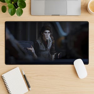 May include: Black rectangular mousepad featuring a character from the animated series Arcane. The character is a man with dark hair, wearing a vest and a red tie. The background is a dark, industrial setting.