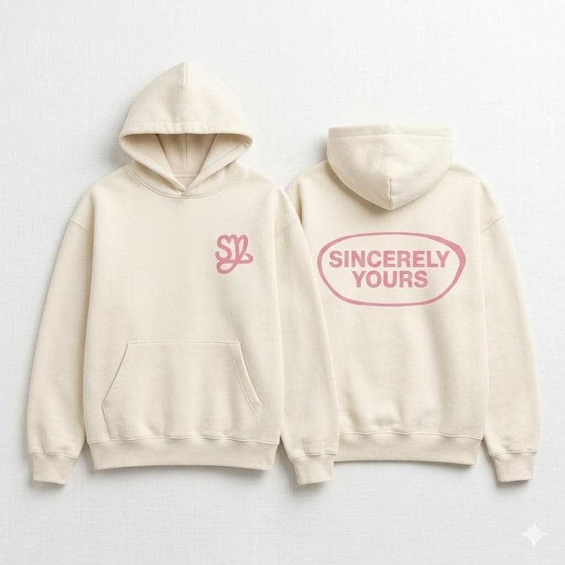 May include: Two cream-colored hoodies with attached hoods. One hoodie has a pink "SZ" logo on the chest. The other hoodie has the words "Sincerely Yours" in a pink oval on the back. Both hoodies have a front pocket.