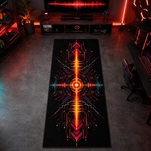 May include: A rectangular desk mat featuring a black background with a vibrant, symmetrical digital circuit pattern in shades of orange, red, and cyan. The design centers on a glowing circular motif with radiating lines and data-like geometric shapes.