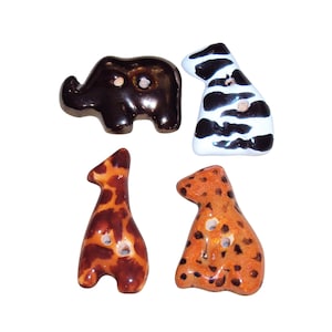 May include: Four animal-shaped buttons featuring a dark brown elephant, a white and black zebra, a brown and orange giraffe with spots, and an orange leopard with dark spots. Each button has two holes for attachment and a smooth, glossy finish.