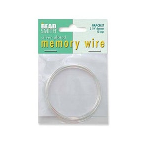 May include: A package of silver-plated memory wire for making bracelets. The package is green and yellow and says "Bead Smith" and "silver-plated memory wire". The package also says "bracelet 3 1/4" diameter 12 loops".