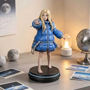 May include: A figurine of a woman with long blonde hair wearing a blue puffer jacket and skirt. The figure is standing on a black circular base with a blue light. The figurine is posed with one hand outstretched. The background includes a globe, a lamp, and pictures of the moon.