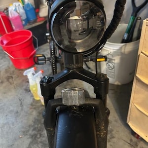 May include: A set of three ceramic mugs with a speckled, matte finish. The mugs are in shades of cream, light gray, and dark gray. Each mug has a simple, minimalist design and a rounded handle.