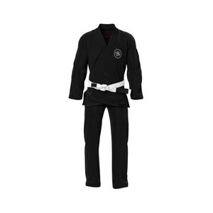 May include: A black martial arts uniform, or gi, with a white belt. The gi features a v-neck jacket and pants. A circular logo is visible on the upper left chest area of the jacket. The uniform is displayed against a white background.