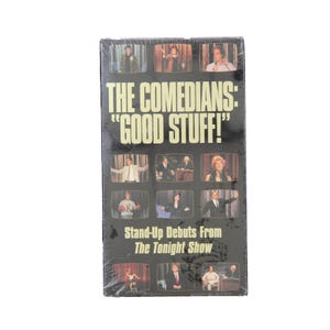 Puede incluir: Una cinta VHS negra titulada "THE COMEDIANS: 'GOOD STUFF!'" con debuts de stand-up de The Tonight Show. La portada muestra un collage de imágenes de comediantes actuando en el escenario.