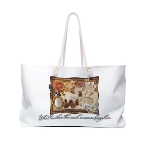 May include: White tote bag with a cream-colored rope handle. The bag features a framed collage with a rose, butterflies, and text that reads "What touches the soul is never forgotten."