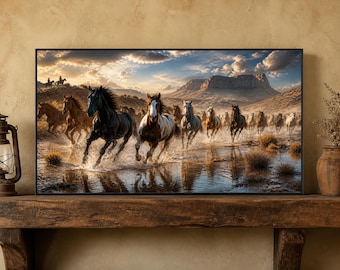 May include: A framed landscape wall art print depicting a herd of horses galloping through shallow water in a desert environment. The scene features a black horse and a brown and white horse in the foreground, with mountains and a cloudy sky.