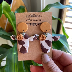 Cow Polymer Clay Earrings | Jewelry, Cows, Cow print, earrings, clay earrings, handmade, gift ideas, floral, flowers, cows and flowers