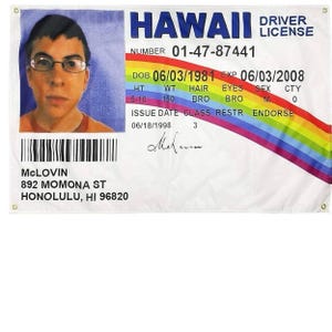 May include: A white banner featuring a mock Hawaii driver's license with a photo of a person wearing glasses. The banner reads "HAWAII DRIVER LICENSE" and includes details like "MCLOVIN" and an address. A rainbow design is also present.