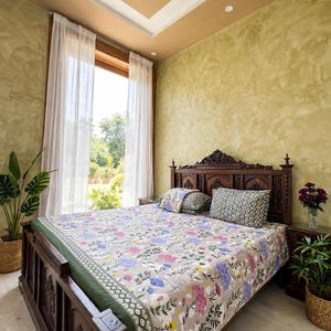 May include: A wooden bed frame with a carved headboard and footboard, featuring a beige bedspread with a floral pattern in pink, blue, and green. The bed includes two patterned pillows and a solid green accent layer along the edge of the mattress.
