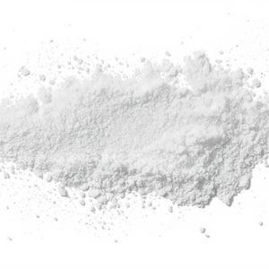May include: A close-up of a pile of white powder on a white background. The powder has a granular texture and is finely ground. The powder is concentrated in the middle and spreads out at the edges.