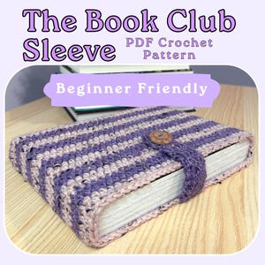 May include: A crochet book sleeve featuring alternating horizontal stripes of purple and light pink yarn. The sleeve includes a central strap secured by a round brown wooden button. Text on the image reads: The Book Club Sleeve PDF Crochet Pattern.