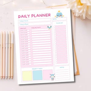 May include: A daily planner sheet with a pink and white color scheme, featuring the text DAILY PLANNER, sections for Today's Focus, Today's Mood, Date, Time Slot, Task/Activity, To-Do List, Priority Tasks, and Notes, with small animal illustrations.