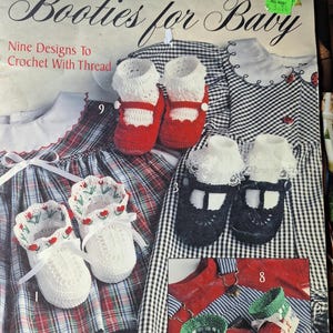 May include: A Leisure Arts craft leaflet titled Booties for Baby, featuring nine crochet designs. The cover displays various handmade baby booties, including red and white pairs, white booties with red tulips, and green and red booties with text.