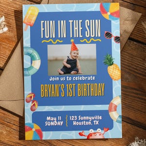 May include: A blue birthday invitation with the text "FUN IN THE SUN" and "BRYAN'S 1ST BIRTHDAY." The invitation includes a photo of a baby wearing a party hat, and beach-themed illustrations like a pineapple, sunglasses, and a crab.