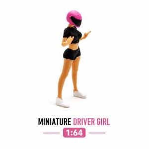 May include: Miniature figurine of a driver girl wearing a pink helmet, black top, and shorts. The figure is standing with arms raised, wearing white sneakers. The text "MINIATURE DRIVER GIRL" and "1:64" are below the figure.